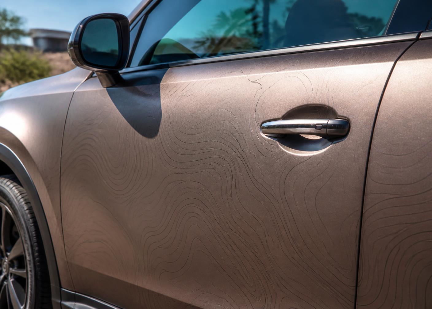 Close view of a vinyl wrap panel on a car door in daylight